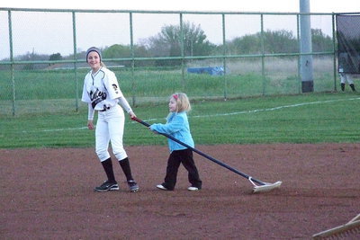 Image: Britney Chambers and her Lady Gladiator teammates worked hard for the win over Itasca with biggest-little fan Hannah Rowe pitching in.