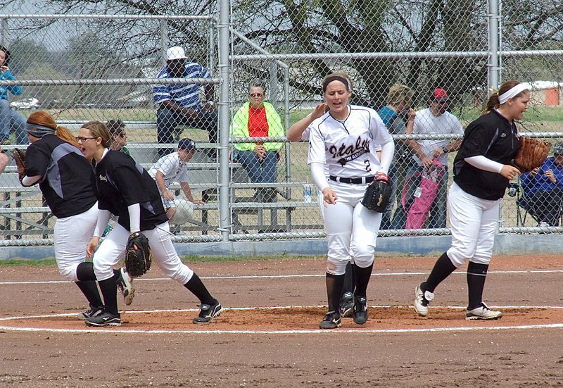 Image: Lady Gladiator infielders Katie Byers, Bailey Eubank, Madison Washington and Paige Westbrook break the huddle and disperse to their positions during a district win over the Frost Lady Polar Bears.