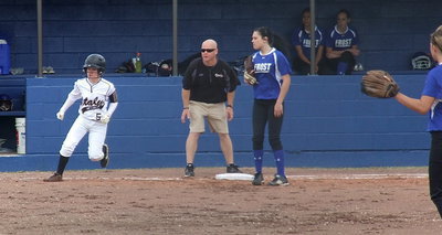Image: Italy’s first base coach Michael Chambers directs Tara Wallis(5) after she hits against Frost.
