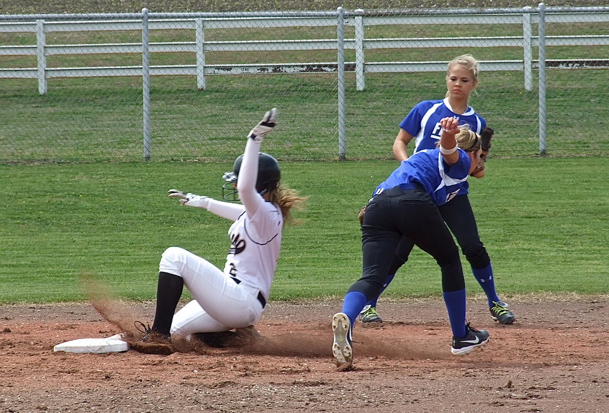 Image: Italy’s Madison Washington(2) beats the tag as she slides into second base.