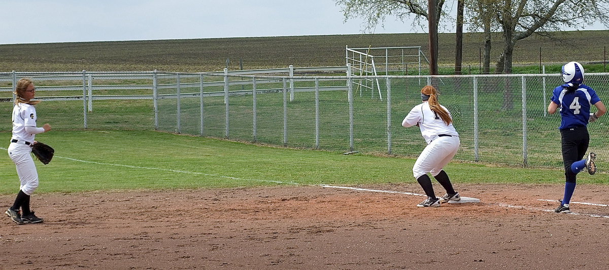 Image: Second baseman Bailey Eubank(1) fields a grounder and then throws to Katie Byers(13) at first base for an out against Frost.