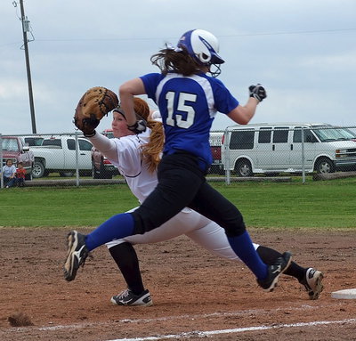 Image: First baseman Katie Byers(13) stretches for the catch but Frost eventually is called safe after the out call is overruled as close plays began going in favor of Frost.