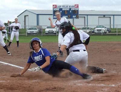 Image: Jaclynn Lewis(15) leaves the mound to cover a bunt but Frost beats the throw home as Alyssa Richards(9) attempts to make the tag.