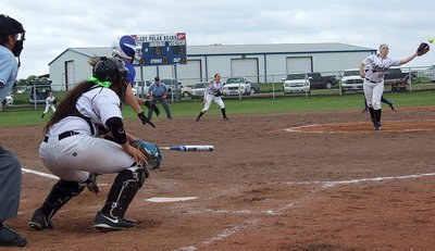 Image: Frost comes from behind to build a 5-3 lead over Italy as pitcher Jaclynn Lewis(15) reaches for a line-drive hit back towards the mound.