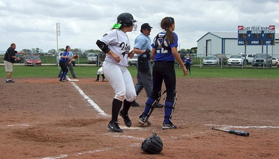 Image: Alyssa Richards(9) reaches home plate to tie the game 5-5.