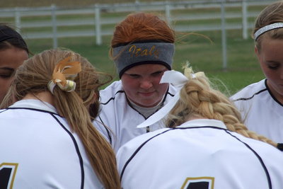 Image: Senior Katie Byers(13) is unable to hide her pride during the team’s post-game prayer.