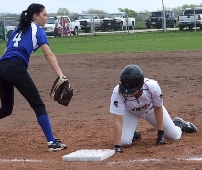 Image: Jaclynn Lewis(15) dives back to first base with Frost trying to keep her from stealing second.