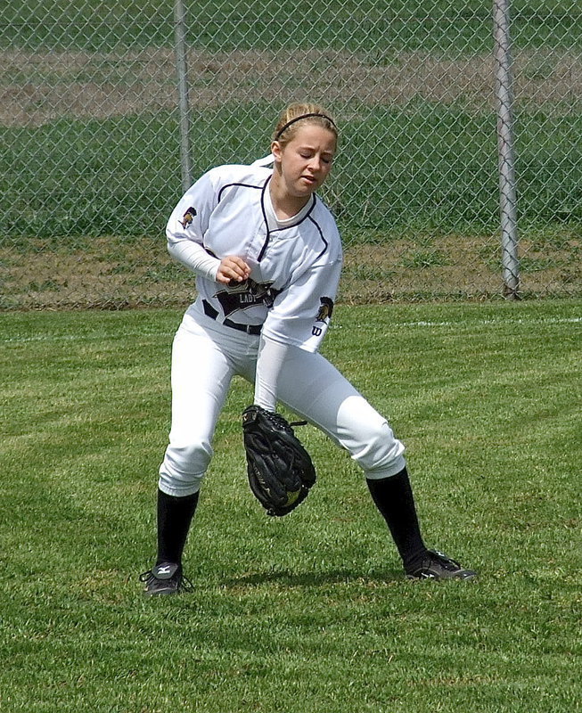 Image: Italy’s right fielder Britney Chambers field s a warmup grounder between innings.