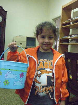 Image: Caty Betencourt, age 5, is ready with bucket in hand for hunting the best eggs.