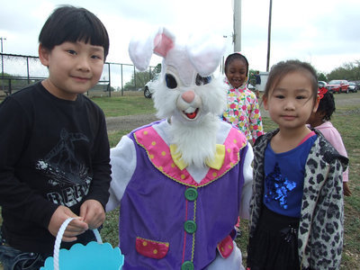 Image: Evan, 6, and Annie, 5,  smile with the Easter Bunny.