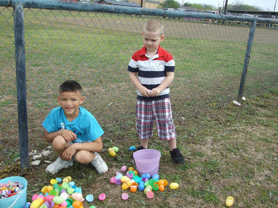 Image: Hayden Ellis and Matthew Cook are looking for the best egg in their baskets.  Matthew is 4 and Hayden is 7.