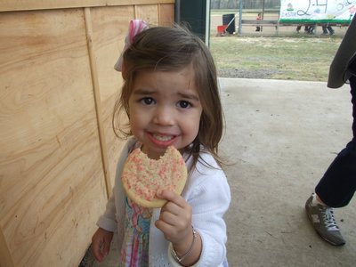Image: Avery Garcia enjoys a sprinkled sugar cookie after the egg hunt.