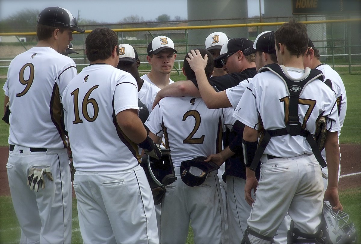 Image: Appreciating the effort by pitcher Caden Jacinto(2) on the mound are Coach Ward and the rest of his Gladiator teammates.