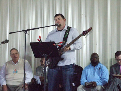 Image: Shaun Roberts from Family Fellowship Praise Band led the congregation in song.  His father, Keith, and mom, Ruth, and Ken Harris played in the band.