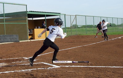 Image: Tara Wallis(5) hits an RBI double as Kelsey Nelson(14) races home from third base.