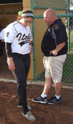 Image: Head Coach Wayne Rowe talks with his anchor, catcher Alyssa Richards(9) after the win against Grand Prairie Advantage.