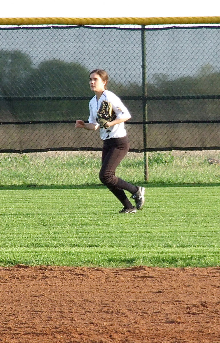 Image: Cassidy Childers(3) backs up a play in left field.