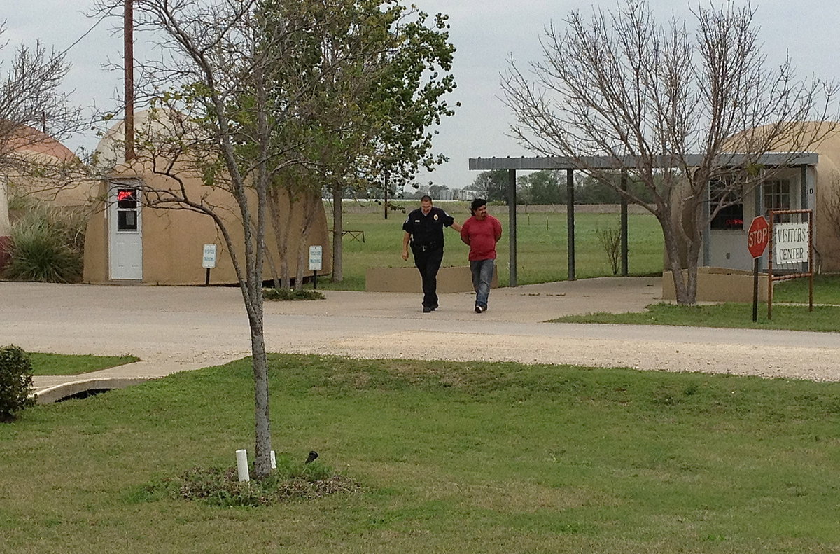 Image: Milford Police Chief Carlos Phoenix emerges with the suspect in handcuffs.