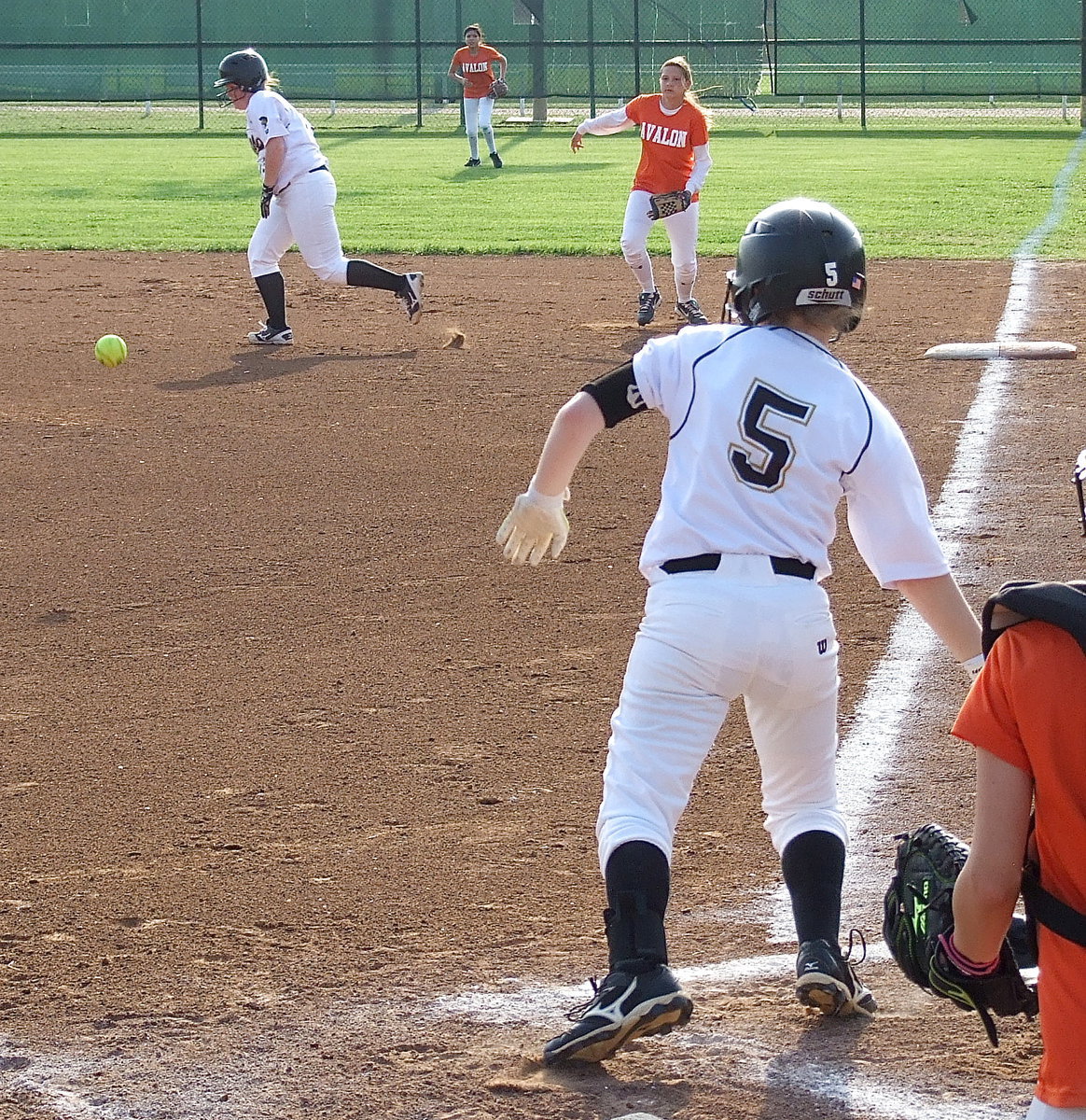 Image: Tara Wallis(5) singles to advance Katie Byers(13) to second base.