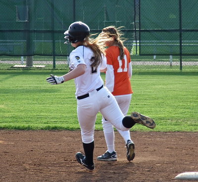 Image: Madison Washington(2) turns and looks around first base.