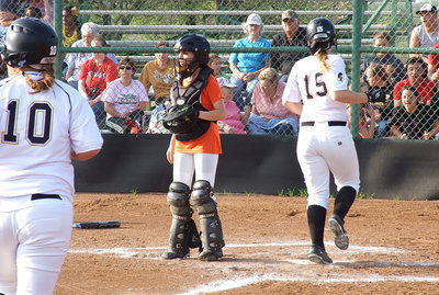 Image: Jaclynn Lewis(15) scores followed by Paige Westbrook(10) with home plate more like a revolving door for Italy’s base runners this season.