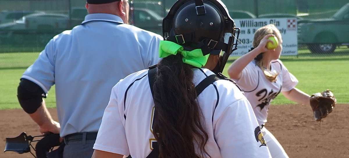 Image: Catcher Cam: Alyssa Richards(9) eyes pitcher Jaclynn Lewis(15) who covers a bunt and then throws to first base for the out.