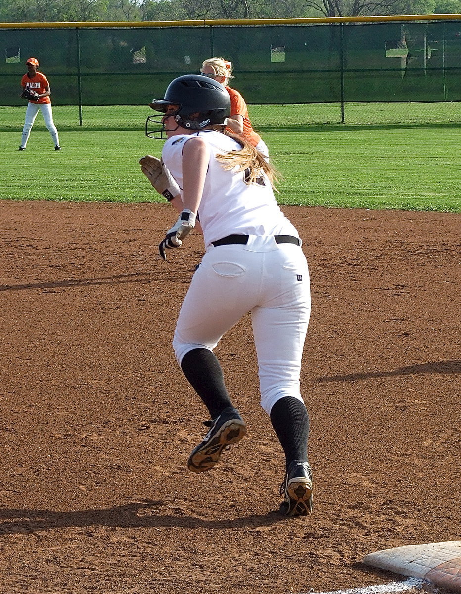 Image: Madison Washington(2) blasts off to second base.