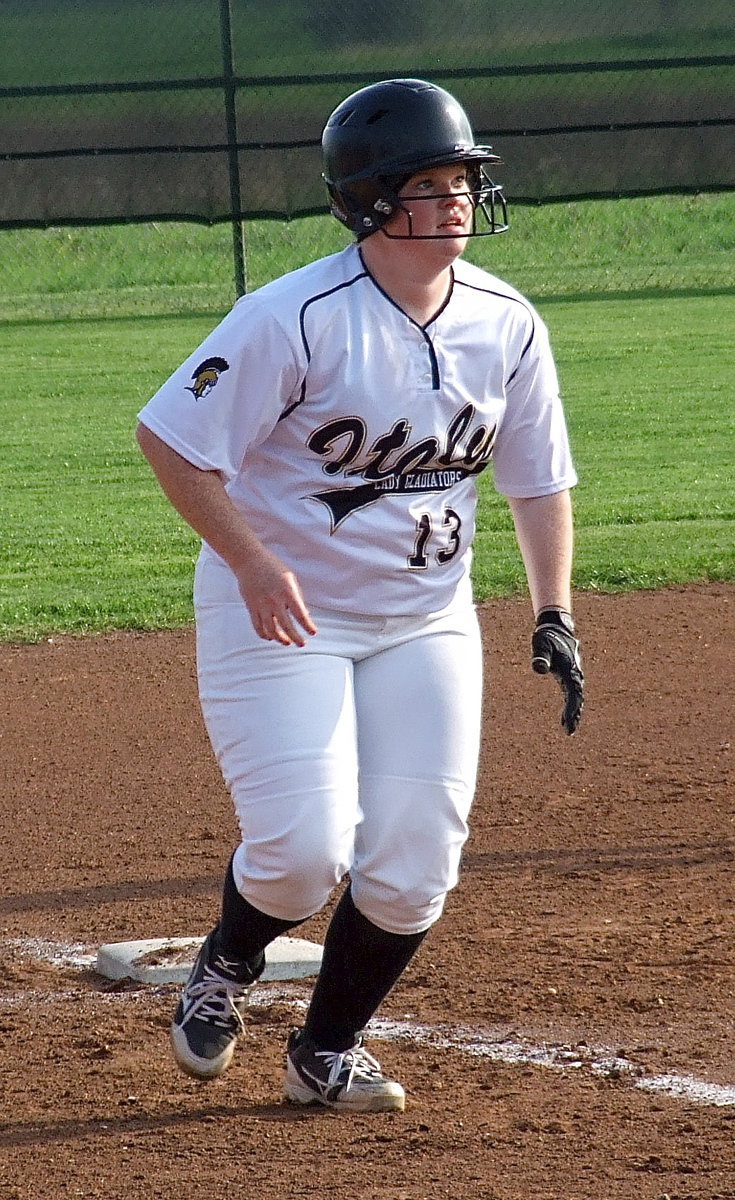 Image: Katie Byers(13) reacts to a hit ball and hurries home for an Italy run.