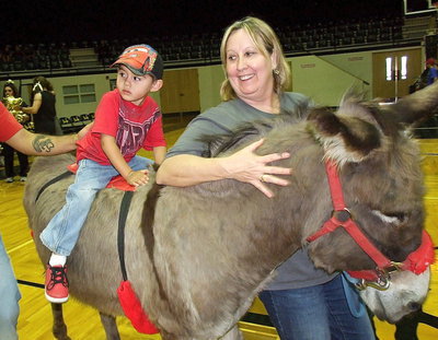 Image: Kim Varner helps give the little tikes donkey rides around the court during intermission.