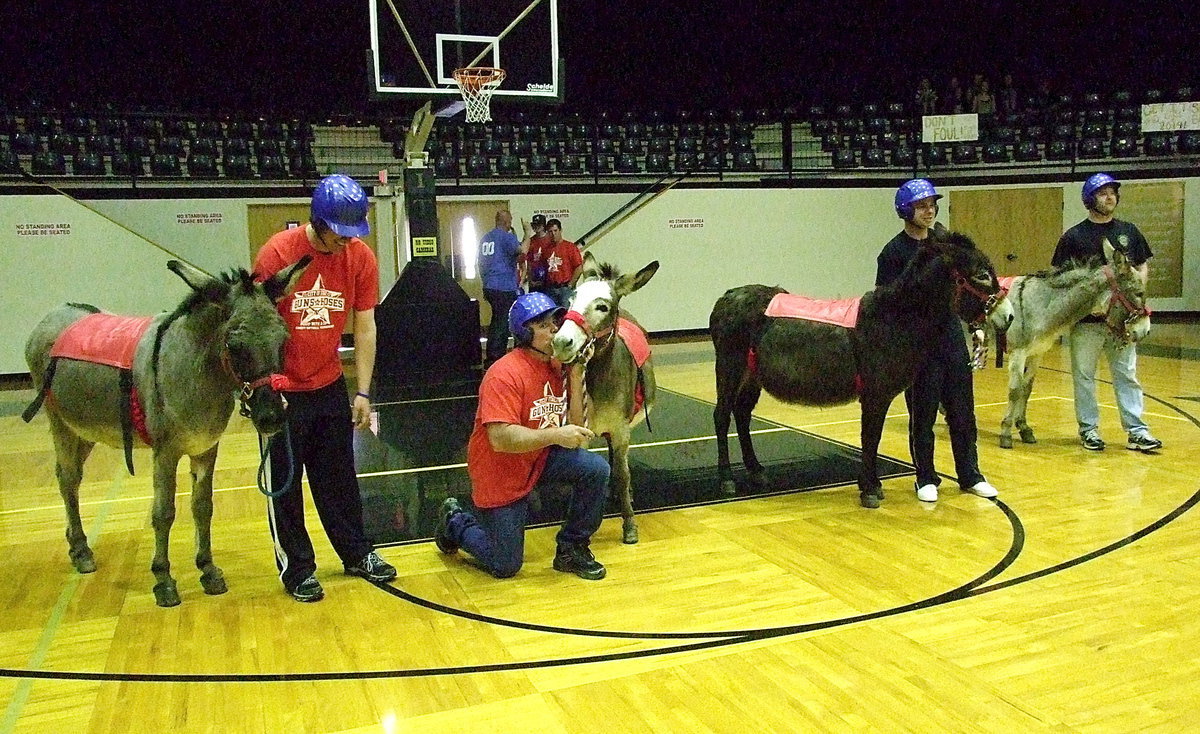 Image: Jackie Cate kisses his own arse for luck at the Guns-n-Hoses donkey basketball team, as Italy firefighters and Italy Police officers, get ready to embarr_ass_themselves.