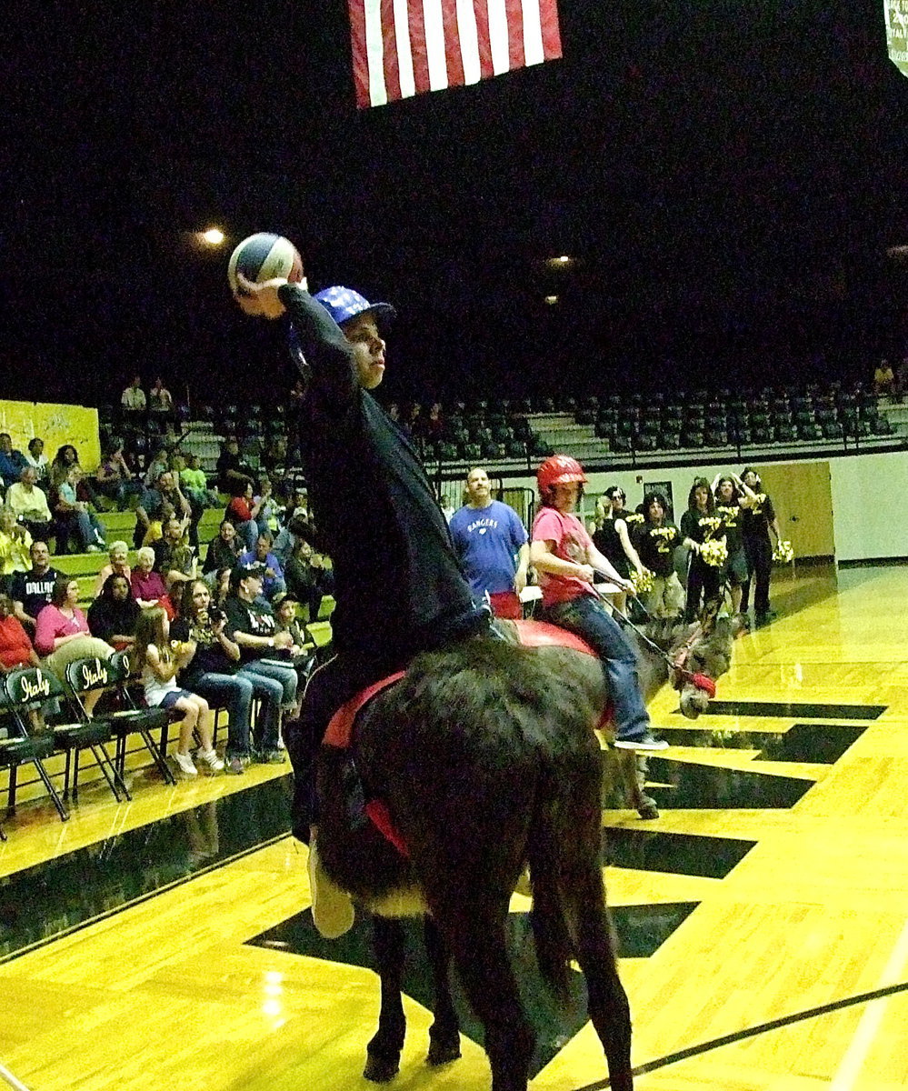 Image: Italy Police officer Daniel Pitts aims and shoots hoping to score a goal for the Guns-n-Hoses team.