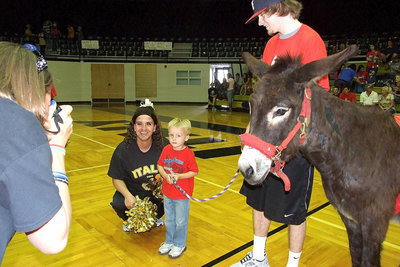 Image: There are some pictures you hope never come out nor make it into the family photo album as Case Campbell hopes for the best while posing with cheerleader Sal Ramirez during intermission of the donkey basketball games.