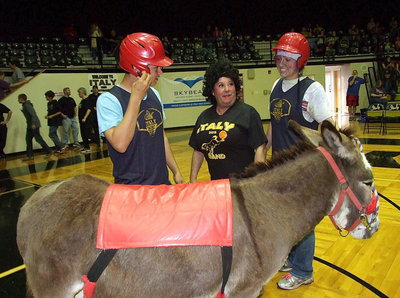 Image: Members of the Hollywood Hero’s Donkey Basketball Team, Reid Jacinto and Jaclynn Lewis, receive a scare and words of encouragement from cheerleader Larry Eubank.