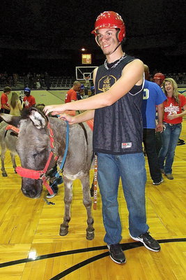 Image: Cole Hopkins of Hollywood’s Heroes gets matched up with the tallest donkey in the stable.