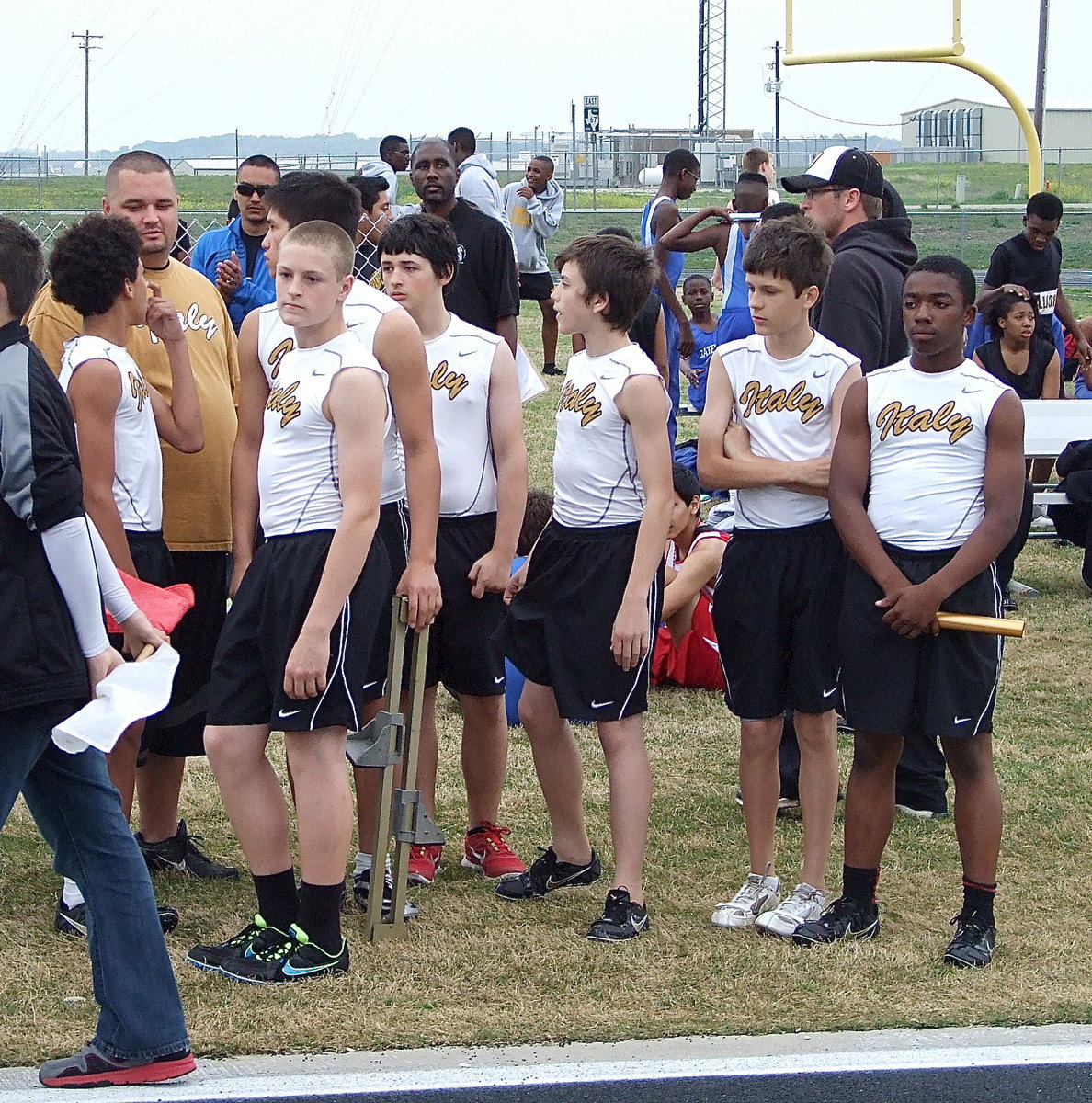 Image: Tylan Wallace, Italy Track Coach Brandon Duncan, Clay Riddle, Elliott Worsham, Dylan McCasland, Ty Hamilton and Kendrick Norwood get ready to support each other during the relay race.