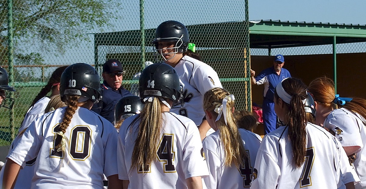 Image: Leaping home is senior Alyssa Richards(9) after recording her fourth home run of the season and her first grand-slam by sailing the pitch well over the left field fence.