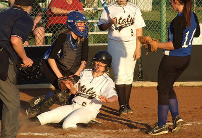 Image: Lady Gladiator freshman Hannah Washington(6) gives a great effort sliding into home but is called out as she peers at the umpire.