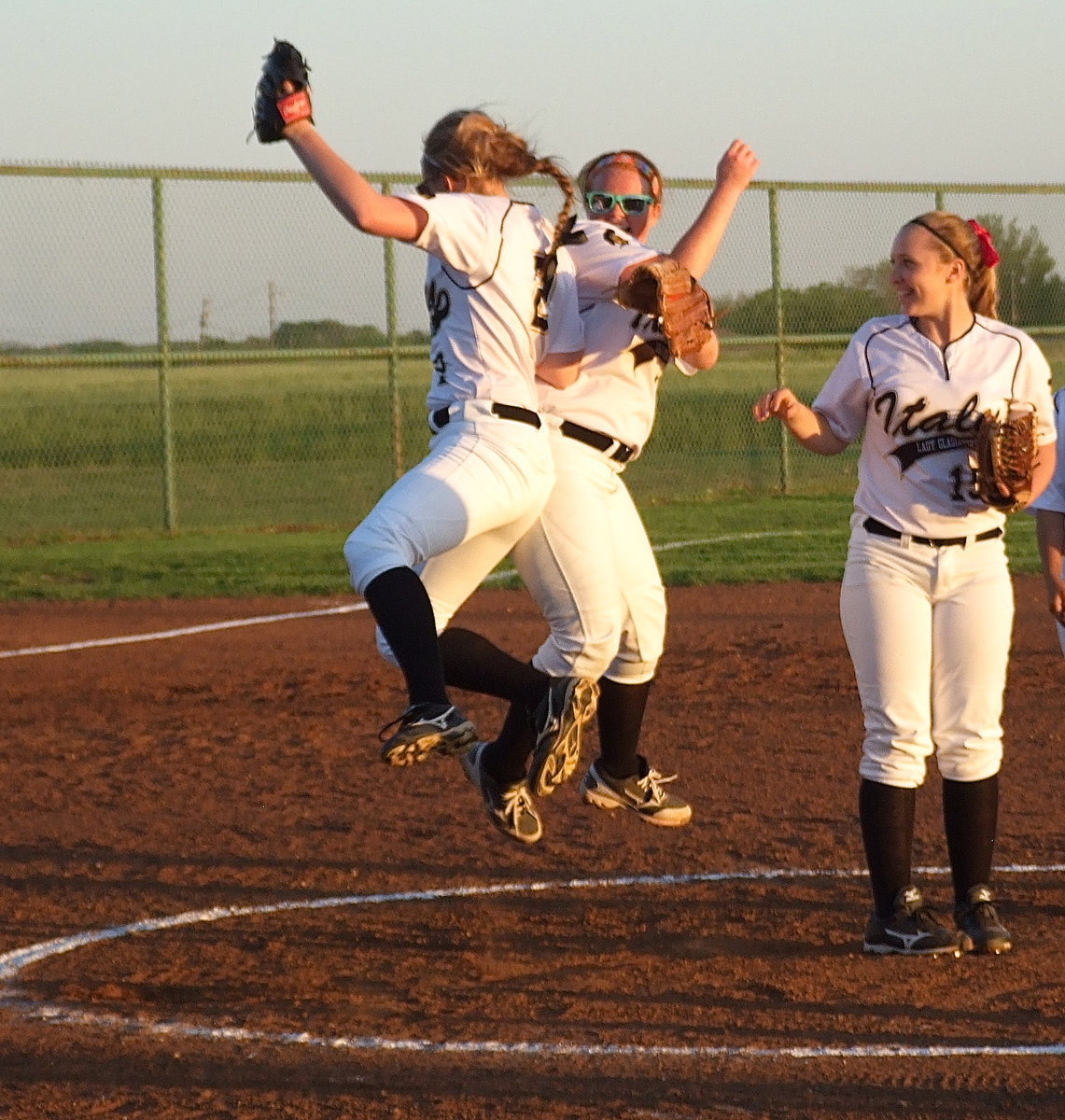 Image: Madison Washington(2) and Katie Byers(13) celebrate the final out in style as pitcher Jaclynn Lewis(15) gets a chuckle out of their enthusiasm.