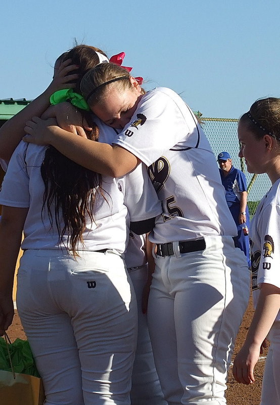 Image: Pitcher Jaclynn Lewis(15) embraces her anchor, senior catcher Alyssa Richards(9) during a between games ceremony celebrating Senior Day.