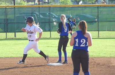 Image: Junior slugger Paige Westbrook(10) blasts a triple into the right field gap.