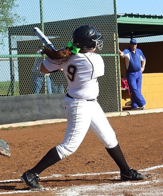 Image: Going pasture during Senior Day is senior Alyssa Richards(9) who sends a shot well beyond the left field fence.