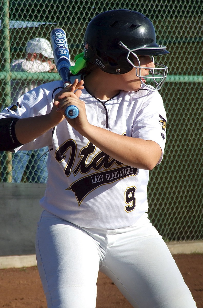 Image: Senior Alyssa Richards(9) gets comfortable while waiting for the Covington pitch.