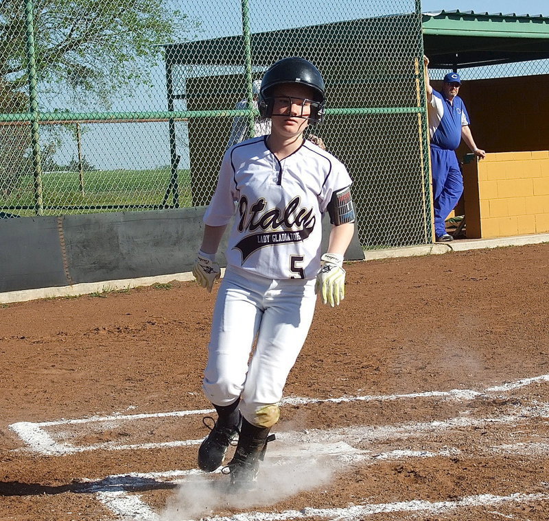 Image: Italy sophomore Tara Wallis(5) crosses home plate.