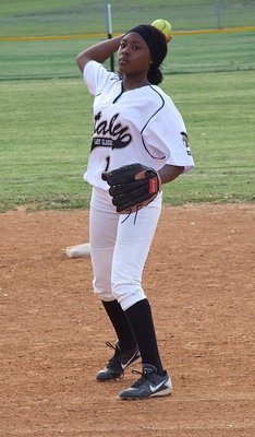 Image: Freshman K’Breona Davis(11) throws to first base.