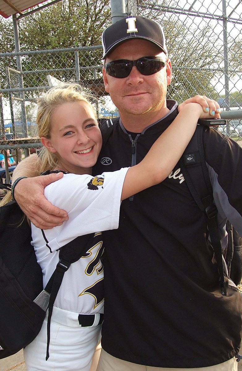 Image: Happy coach and proud dad, Michael Chambers, gets a hug from his daughter and Lady Gladiator Britney Chambers(4) who had two big catches in right field, one of which was the game-ender.