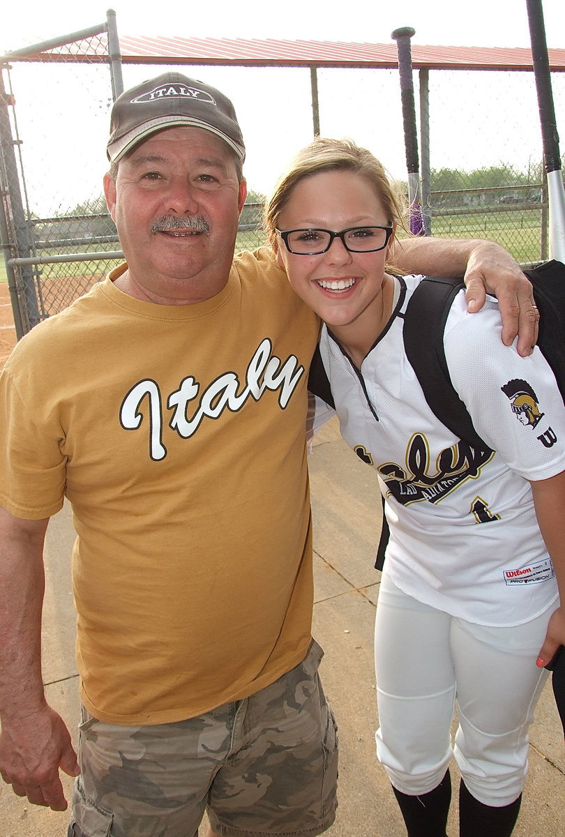 Image: Larry Eubank gets a hug from daughter Bailey Eubank(1) after Italy claims the district championship and prepares for the playoffs.