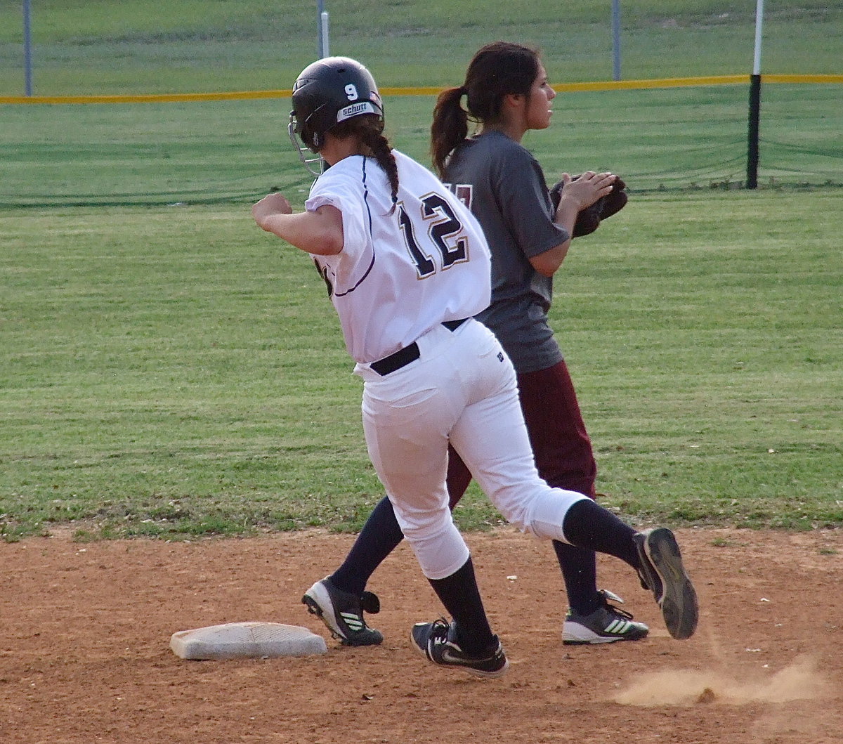 Image: Freshman Lillie Perry(12) cruises past second base and on to third after hitting a triple.