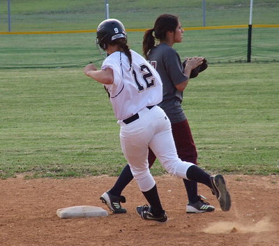 Image: Freshman Lillie Perry(12) cruises past second base and on to third after hitting a triple.