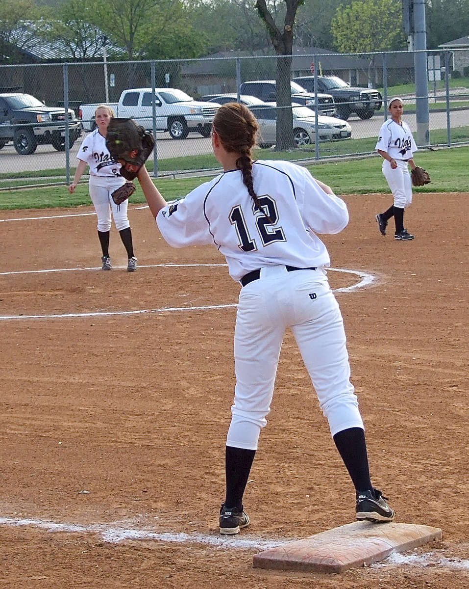 Image: Freshman third baseman Hannah Washington(6) throws on target to freshman teammate Lillie Perry(12) to get the runner out at first base.