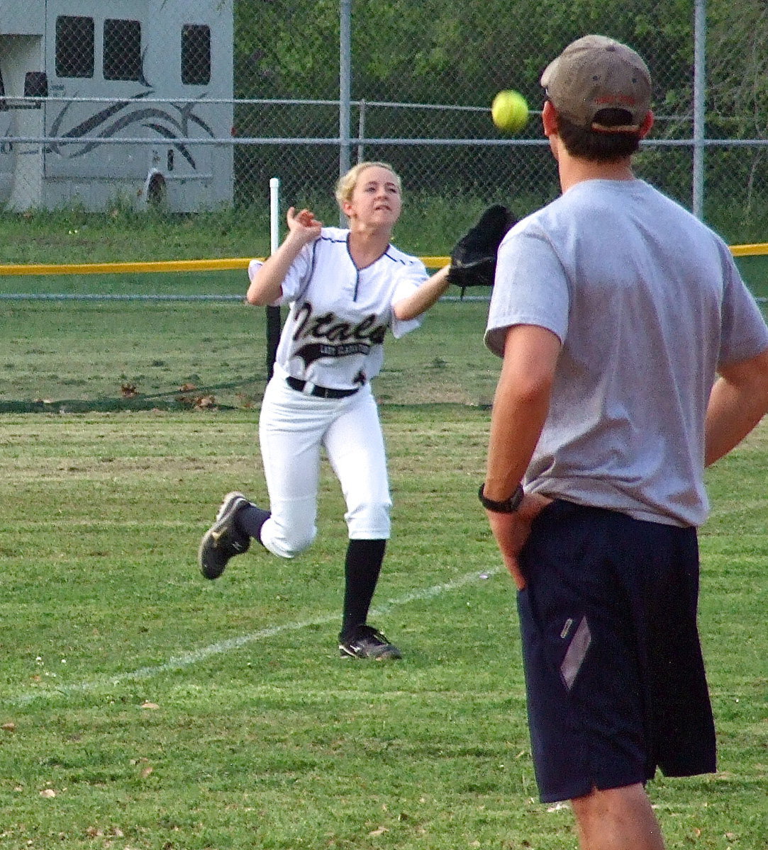 Image: All Faith Family’s coach can do is watch as Italy’s freshman right fielder Britney Chambers(4) makes the catch in foul territory for an out.